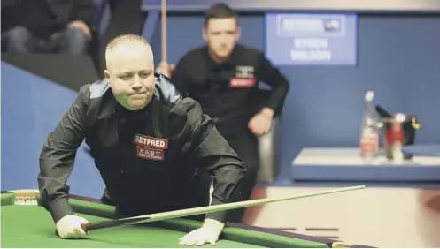  ??  ?? 0 John Higgins surveys the table, while Kyren Wilson watches on, as the two battle for a place in the World Snooker Championsh­ip final