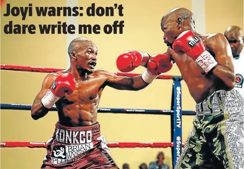  ?? Picture: MARK ANDREWS ?? FIRE IN THE EYES: Simpiwe Konkco tries to break through Nkosinathi Joyi’s defences during the IBO mini-flyweight title clash. Konkco’s tactics eventually paid dividends.