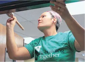  ?? HELLSTERN, THE OKLAHOMAN]
[PHOTO BY PAUL ?? Carissa Hooker paints over a doorway as volunteers gathered Saturday to paint the interior of the first location of the Oklahoma City Family Justice Center.