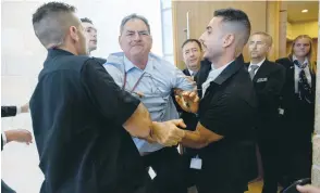  ?? (Yonatan Sindel/Flash90) ?? HIZKY SIVAK of the Emek Hefer Regional Council is removed by security personnel from a stormy meeting and vote at the Knesset Finance Committee on the Arnona Fund, last Monday.