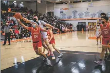  ?? NATHAN BURTON/Taos News ?? The Sundevils’ Joshua Coriz, front, battles for possession of the ball against the Tigers’ Elden Torres during a game Friday (Feb. 4).