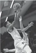  ??  ?? Michigan’s Charles Matthews, left, goes up for a shot against Villanova’s Joe Cremo on Wednesday.