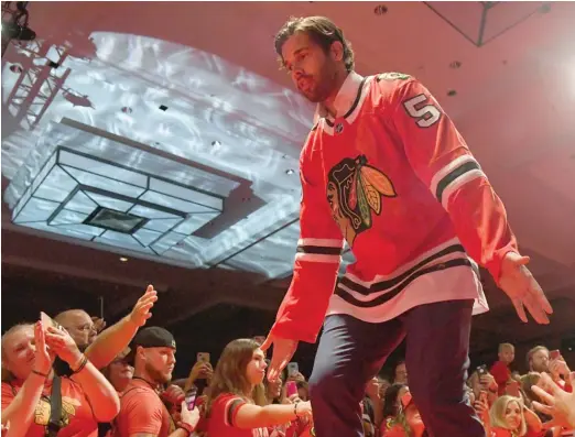  ?? ANNIE RICE/AP ?? Corey Crawford, who suffered a still-mysterious head injury in December, is introduced to fans Friday during the first day of the Blackhawks Convention.