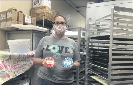  ?? RACHEL RAVINA - MEDIANEWS GROUP ?? Lochel’s Bakery Owner Kathleen Lochel poses for a photo Friday morning inside her store, located at 57 S. York Road in Hatboro, holding election-themed cookies: Biden 2020 in one hand and Trump 2020 in another.