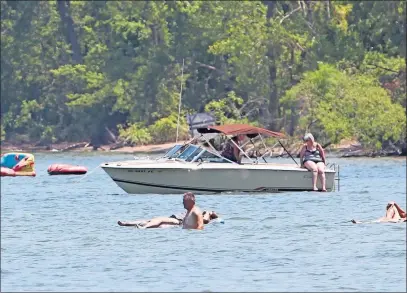  ?? [STEVE STEPHENS/DISPATCH] ?? Sun lovers soak up the rays offshore at Kelleys Island.