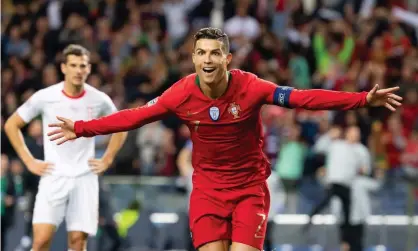  ??  ?? Cristiano Ronaldo celebrates after scoring the second goal of his hat-trick against Switzerlan­d. Photograph: TF-Images/Getty Images