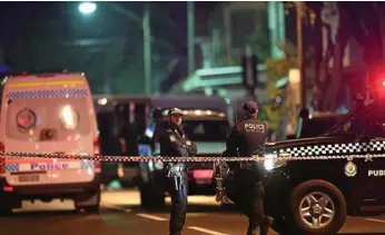  ??  ?? VIGILANT: Australian Federal Police and NSW Police during counter-terrorism raids in Surry Hills in inner Sydney on Saturday night. PHOTO: SAM MOOY/AAP