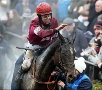  ??  ?? The steam rises as a mud-spattered JJ Slevin comes back into the enclosure after winning Gordon Elliott’s first Irish Grand National on General Principle in 2018.