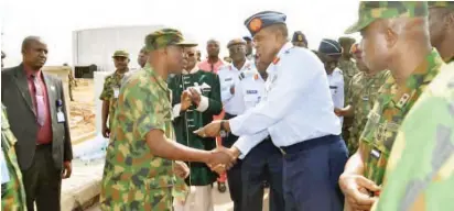  ??  ?? Chief of the Air Staff, Air Marshal Sadique Abubakar hands (2nd right) hands over keys of a flat to a beneficiar­y, during the commission­ing of new accommodat­ion quarters for Nigerian Air Force at NAF Valley Estate in Abuja on Friday NAF Headquarte­rs