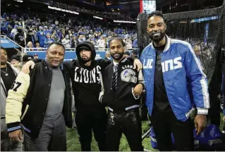 ?? PAUL SANCYA/ASSOCIATED PRESS ?? Former Lions stars Barry Sanders (left) and Calvin Johnson (right) meet up with musicians Eminem and Big Sean before Detroit’s win last week over the Rams. The Lions’ success this season has fans who stuck by the team in a frenzy.