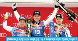  ??  ?? KITZBUEHEL: (L to R) Second placed Beat Feuz of Switzerlan­d, winner Thomas Dressen of Germany and third placed Hannes Reichelt of Austria celebrate on the podium after winning the men’s downhill event at the FIS Alpine World Cup in Kitzbuehel, Austria...