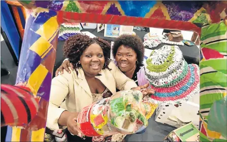  ?? Picture: EUGENE COETZEE ?? BRIGHT IDEAS: A group of visually impaired artists have put their skills on show in an exhibition of items made entirely from recycled materials. The exhibition opened yesterday, World Environmen­t Day, and will run until Saturday in the Pick n Pay forecourt at the Walmer Park Shopping Centre. Showing some of the colourful handmade goods that are on display are Lutho Xintolo, left, and social worker and Retina SA volunteer Boniswa Citwa.