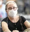  ?? AP ?? A PASSENGER wears a mask as a precaution against the spread of Covid-19 as she arrives at Sao Paulo Internatio­nal Airport in Brazil. |