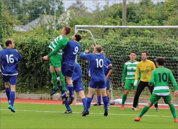  ??  ?? Killarney Celtic’s Matt Keane outgunned in the air by Killarney Athletic’s Daithi Casey (9) and Shane Lynch (10) as Athletic clear their lines during the Athletic Celtic derby encounter in the Denny Premier League Division 1 final at Mounthawk Park on...