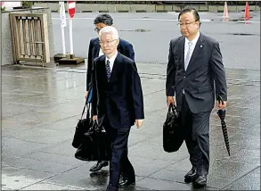  ?? AP/KOJI HARADA ?? Tsunehisa Katsumata (center), former chairman of Tokyo Electric Power Co., accompanie­d by his lawyers, arrives Friday at Tokyo District Court for the start of a trial on charges of negligence in the 2011 Fukushima nuclear disaster.