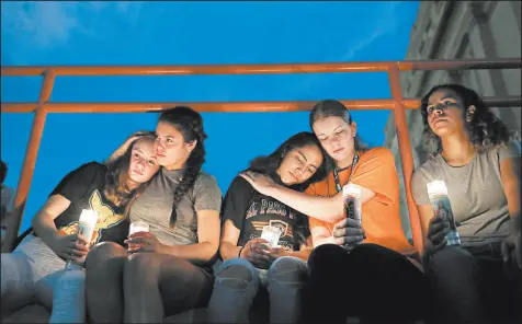  ?? JOHN LOCHER/AP ?? Melody Stout, from left, Hannah Payan, Aaliyah Alba, Sherie Gramlich and Laura Barrios comfort each other during a vigil Aug. 3 in El Paso, Texas. The mass shooting was one of 41 this year, and one of nine to occur in a public place.