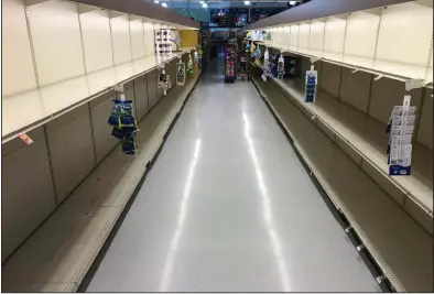  ?? (AP/Matt Rourke) ?? Empty shelves greeted shoppers Monday at this grocery store in Willow Grove, Pa. Shoppers have been buying up extra quantities of food and home products.