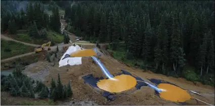  ?? AP PHOTO/BRENNAN LINSLEY ?? In this Aug. 12, 2015, file photo, water flows through a series of retention ponds built to contain and filter out heavy metals and chemicals from the Gold King mine accident outside Silverton, Colo.