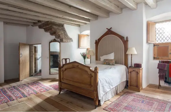  ??  ?? Top: The master bedroom boasts original beams.