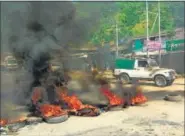  ?? PTI PHOTO ?? Protesters burn tyres in protest against Manipur CM Okram Ibobi Singh’s visit in curfew-bound Ukhrul district of Manipur on Monday.