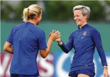  ?? Elsa / Getty Images ?? U.S. players Abby Dahlkemper, left, and Megan Rapinoe were in good spirits on the eve of their semifinal match against England.