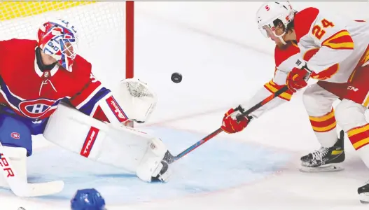  ?? JOHN MAHONEY ?? Calgary Flames forward Brett Ritchie deflects the puck wide past Canadiens goalie Jake Allen during Calgary's 4-1 victory in Montreal on Wednesday.