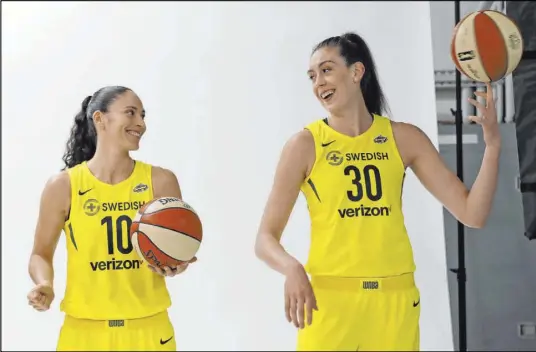  ?? Elaine Thompson The Associated Press ?? Seattle Storm players Sue Bird, left, and Breanna Stewart are leading the charge to make family planning part of the new collective bargaining agreement. Their efforts are helping to destigmati­ze the freezing of eggs.