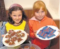  ??  ?? ●●Brownies Ellie Goslin (9) and Georgina Butterwort­h (7) selling cakes at St Paul’s Church