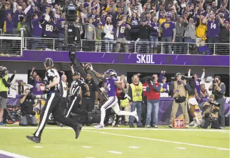  ?? Stephen Maturen / Getty Images ?? Minnesota wide receiver Stefon Diggs celebrates as he sprints to the end zone for the game-winning score as time expires.