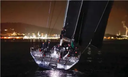  ?? Photograph: Rob Blakers/AAP ?? BlackJack approaches the finish line of the Sydney to Hobart yacht race in darkness in the early hours of Wednesday morning.