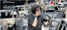  ?? REUTERS Picture: ?? IN SHOCK: A woman reacts as she tries to find her dog, following a wildfire at the village of Mati, near Athens, Greece.