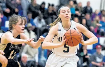  ?? SUPPLIED ?? Niagara's Courtney Kilyk, No. 5, under pressure from Conestoga, passes to a teammate in women's college basketball Wednesday night in Welland.