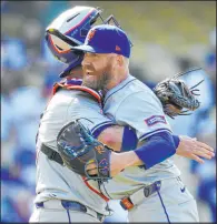  ?? The Associated Press
Ashley Landis ?? Reed Garrett hugs catcher Omar Narvaez after striking out the side in the ninth inning for his first save in the Mets’ victory over the Dodgers.