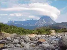  ??  ?? PEMBENTUKA­N awan lentikular yang menyerupai kanta atau topi berlaku di puncak Gunung Kinabalu, kelmarin.