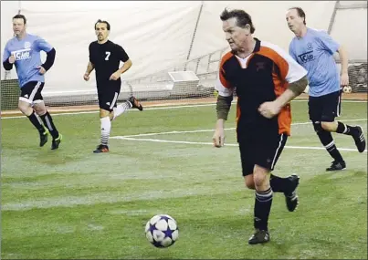  ?? VLADO ZAMECNIK/Special to the Herald ?? Gord McLaren of Penticton Lock & Key tries to pull away from Tony Dias of TC Auto Sales as Mike Beliveau, far left, and Zico Pescada look on during Bad Tattoo Brewery Masters Indoor Soccer League play Sunday at the Adidas Sportsplex. McLaren scored...