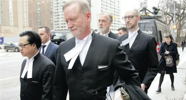  ?? CHRIS HELGREN / REUTERS ?? Crown prosecutor Michael Cantlon and other lawyers leave court Friday in Toronto after the sentencing of serial killer Bruce McArthur.