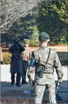  ?? AFP ?? North Korean soldiers staring at South Korean soldiers at the truce village of Panmunjom in the Demilitari­sed Zone dividing the two Koreas on November 27.