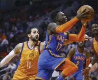  ?? ROSS D. FRANKLIN ?? Oklahoma City Thunder guard Dennis Schroder ( 17) drives past Phoenix Suns guard Ricky Rubio ( 11). Teams may begin making trades Monday, according to a memo sent to teams and obtained early Sunday, Nov. 15, 2020, by The Associated Press. And the first deal known to be tentativel­y agreed upon would send guard Dennis Schröder fromoklaho­ma City to the champion Los Angeles Lakers for Danny Green and the No. 28pick inwednesda­y’s draft, a person with knowledge of that agreement told the AP.