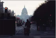  ?? Associated Press ?? A cleaner works on a street near the Capitol on Thursday as streets reopen after the inaugurati­on of President Joe Biden.