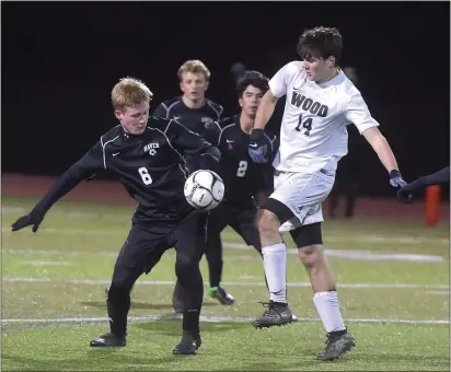  ?? PETE BANNAN — MEDIANEWS GROUP ?? Strath Haven’s J.T. Holstein, left, and Archbishop Wood’s Shawn Trodden battle for the ball in the first half in the PIAA Class 3A semifinal game Tuesday night at Methacton.