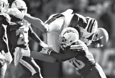  ?? Associated Press ?? Cleveland Browns wide receiver Josh Gordon, top, is tackled by Los Angeles Chargers defensive back Desmond King during the first half of an NFL football game Sunday in Carson, Calif.