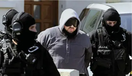  ?? JEAN-SEBASTIEN EVRARD/AFP/GETTY IMAGES ?? Police arrest Forsane Alizza Islamic radical group’s leader, Mohammed Achamlane, in Bouguenais, western France, on Friday.