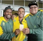  ?? Picture: WERNER HILLS ?? OFF TO THE GAMES: Ikhamva Athletics Club head coach Michael Mbambani, right, with Melikhaya Frans, left, and Thabang Mosiako, two of the athletes he coaches