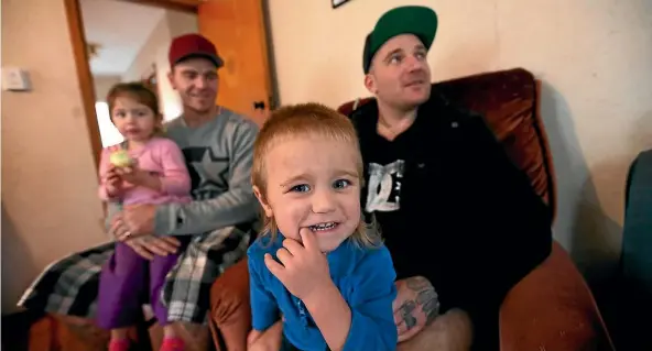  ??  ?? Craig Ryan, left, with children Mia-Rose, 3, and Duke-Lincoln, 1, and brother Aaron, in their damp and mouldy Housing New Zealand home.