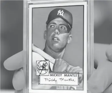  ?? DAVID ZALUBOWSKI / THE ASSOCIATED PRESS ?? This 1952 Topps Mickey Mantle, which was put on display as part of baseball memorabili­a exhibit at the Colorado History Museum on Monday, is owned by Denver lawyer Marshall Fogell and valued at several million dollars.