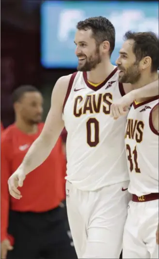  ?? TONY DEJAK — ASSOCIATED PRESS ?? Kevin Love, left, and Jose Calderon celebrate during the first half against the Raptors on April 3. The Cavaliers won, 112-106.