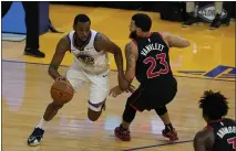  ?? JEFF CHIU — THE ASSOCIATED PRESS ?? Golden State Warriors forward Andrew Wiggins, left, is defended by Toronto Raptors guard Fred VanVleet on Sunday in San Francisco.