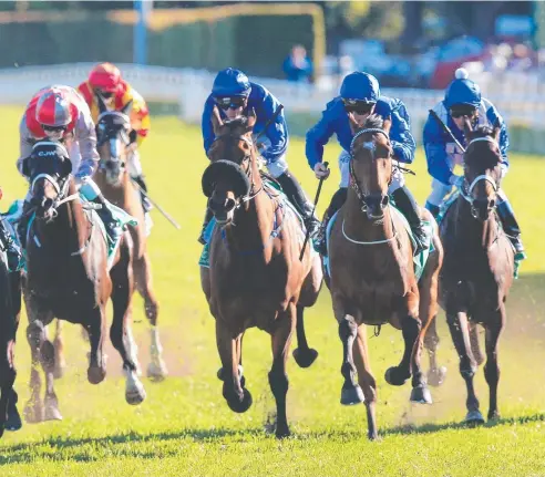  ?? Pictures: MARK EVANS ?? ON CHARGE: Hauraki, ridden by James McDonald (second from right), wins the Epsom Handicap at Royal Randwick by a half head from Dibayani, with a long head to Mackintosh third.