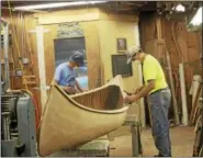  ??  ?? Colebrook Land Conservanc­y members restore the Indian model canoe.