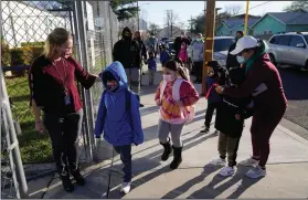  ?? (AP/Marcio Jose Sanchez) ?? Assistant Principal Janette Van Gelderen (left) welcomes students last week at Newhall Elementary in Santa Clarita, Calif. Most of the state’s public school classes have not been held in-person since March 2020.